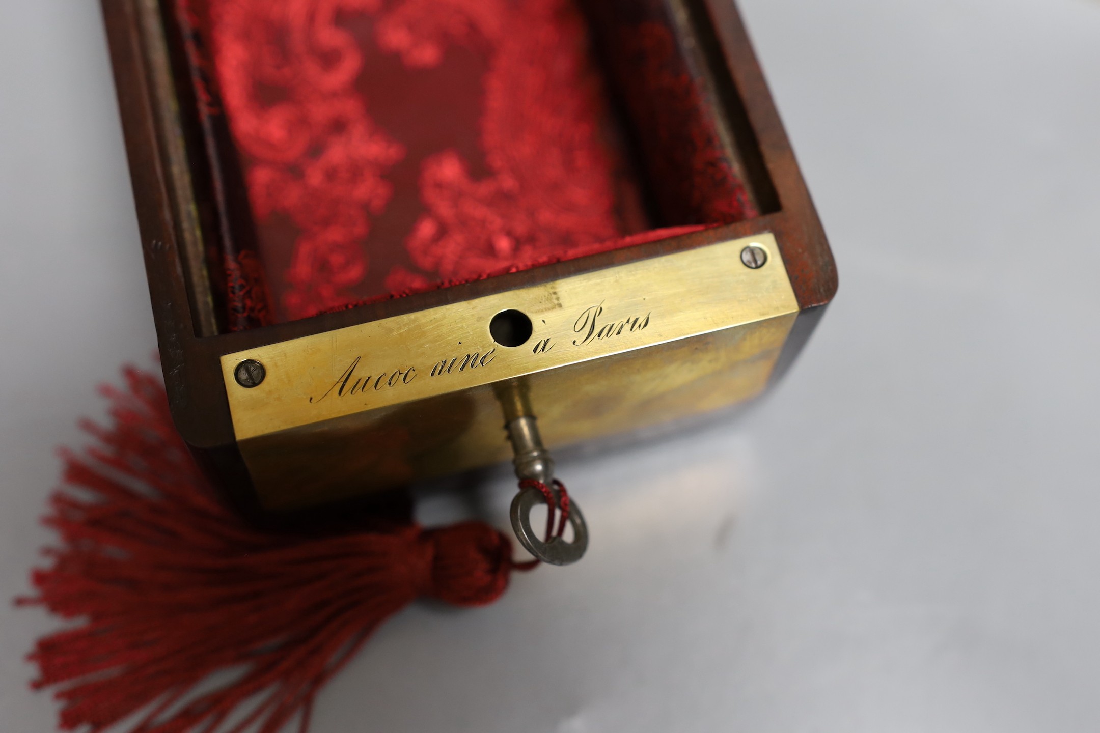 A 19th century Dutch amboyna and brass mounted tea caddy, 14 cm wide and a 19th century French mahogany box by Aucoc Aine a Paris